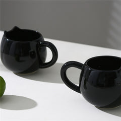 Adorable hand - painted cat - shaped ceramic mug, perfect for coffee or tea.