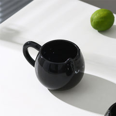 Adorable hand - painted cat - shaped ceramic mug, perfect for coffee or tea.